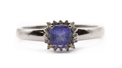 Lot 294 - An 18ct white gold tanzanite and diamond halo cluster ring