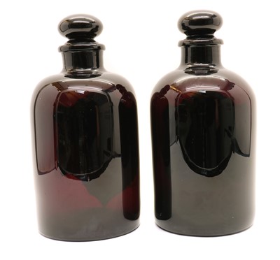 Lot 210 - A pair of amethyst glass apothecary bottles