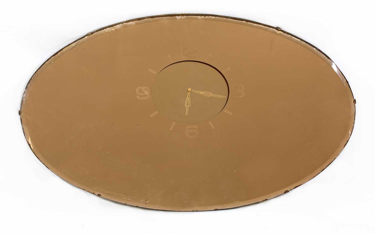 Lot 94 - An Art Deco pink-tinted oval mirror clock