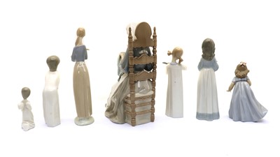 Lot 83 - A collection of seven Nao and Lladro figurines