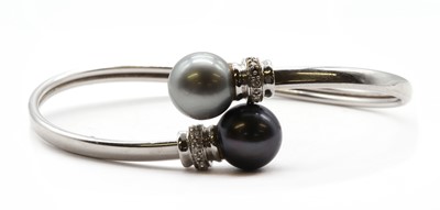 Lot 331 - A white gold cultured Tahitian pearl and diamond torque bangle