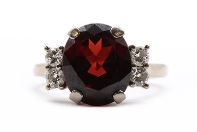 Lot 171 - An 18ct white gold garnet and diamond ring
