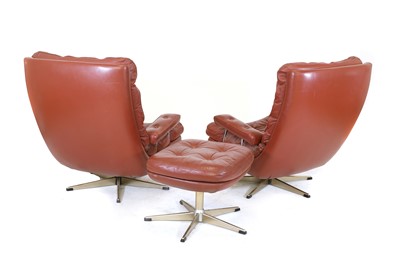 Lot 363 - A pair of Danish leather lounge chairs and an ottoman