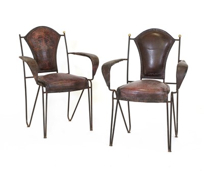 Lot 242 - A pair of unusual iron and leather armchairs