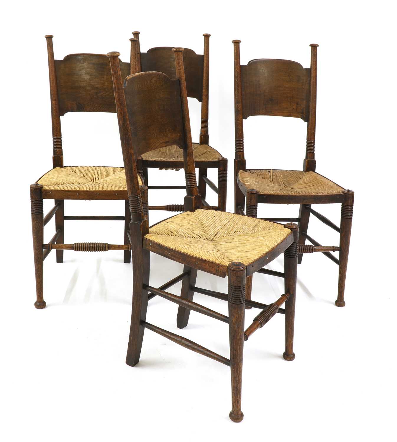 Lot 26 - A set of four oak and rush-seated chairs