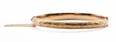 Lot 410 - A 9ct gold hollow oval hinged bangle