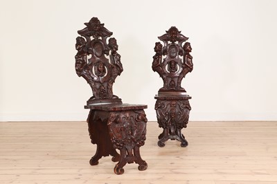 Lot 222 - A pair of walnut sgabello hall chairs