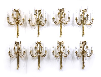 Lot 565 - A set of eight gilt-metal wall lights in the Louis XVI-style