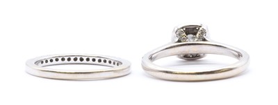 Lot 196 - An 18ct white gold wedding and engagement ring set