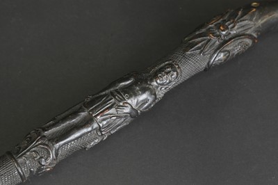 Lot 12 - A carved folk art bog oak walking stick