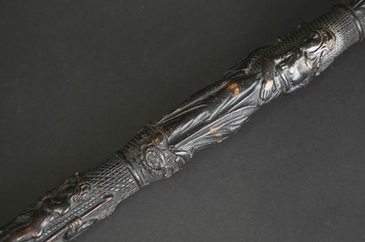 Lot 12 - A carved folk art bog oak walking stick