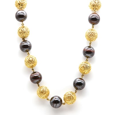 Lot 202 - An 18ct gold filigree style bead and ironstone bead necklace, c.1990