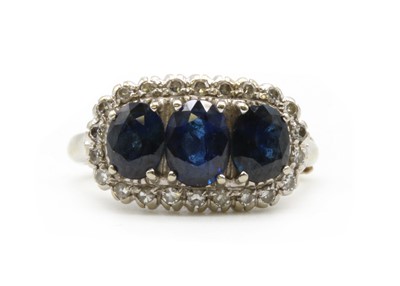 Lot 269 - A white gold sapphire and diamond cluster ring