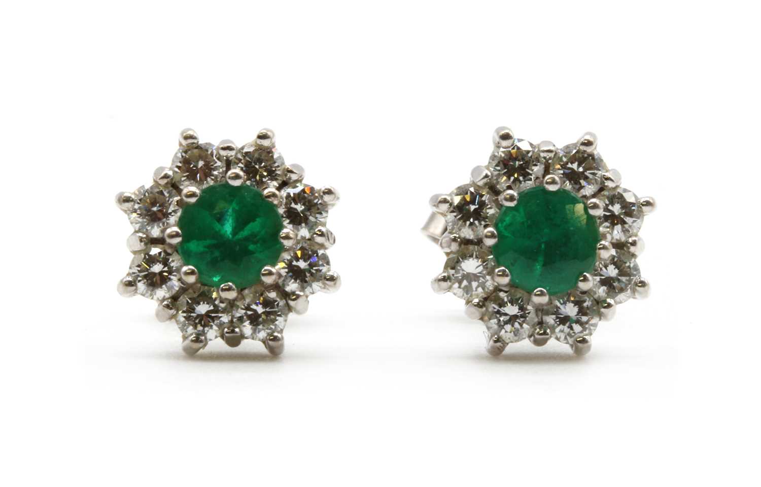 Lot 229 - A pair of white gold emerald and diamond cluster earrings, by Fred Ullmann
