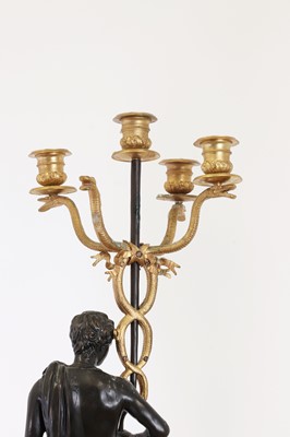 Lot 105 - A pair of gilt and patinated bronze candelabra