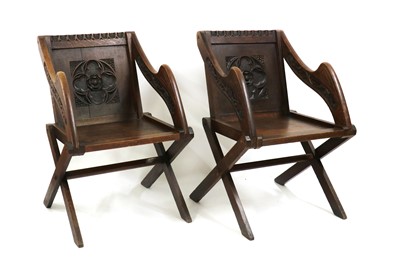 Lot 359 - A pair of carved oak Glastonbury chairs