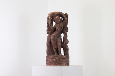 Lot 175 - A carved sandstone or possibly composite figure of a dancing apsaras