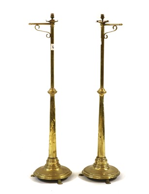Lot 449 - A pair of polished brass standard lamps