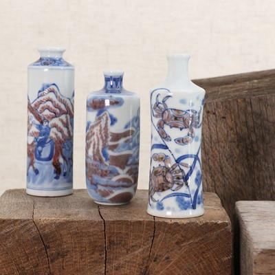 Lot 144 - Three Chinese underglaze blue and copper-red porcelain snuff bottles