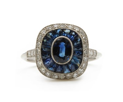 Lot 261 - A sapphire and diamond target style cluster ring