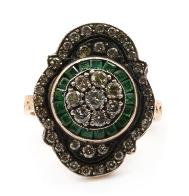 Lot 245 - A silver and rose gold diamond and emerald ring