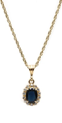 Lot 267 - A gold sapphire and diamond cluster pendant