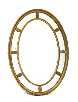 Lot 388 - An oval gilt gesso marginal wall mirror