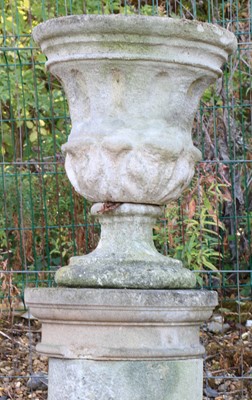 Lot 626 - A near pair of stone urns and associated columns