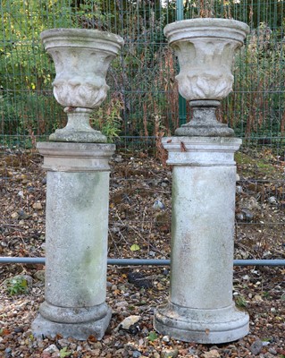 Lot 626 - A near pair of stone urns and associated columns