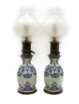 Lot 179 - A pair of blue and white pottery moderator table lamps and shades