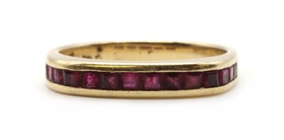 Lot 101 - A gold ruby half eternity ring