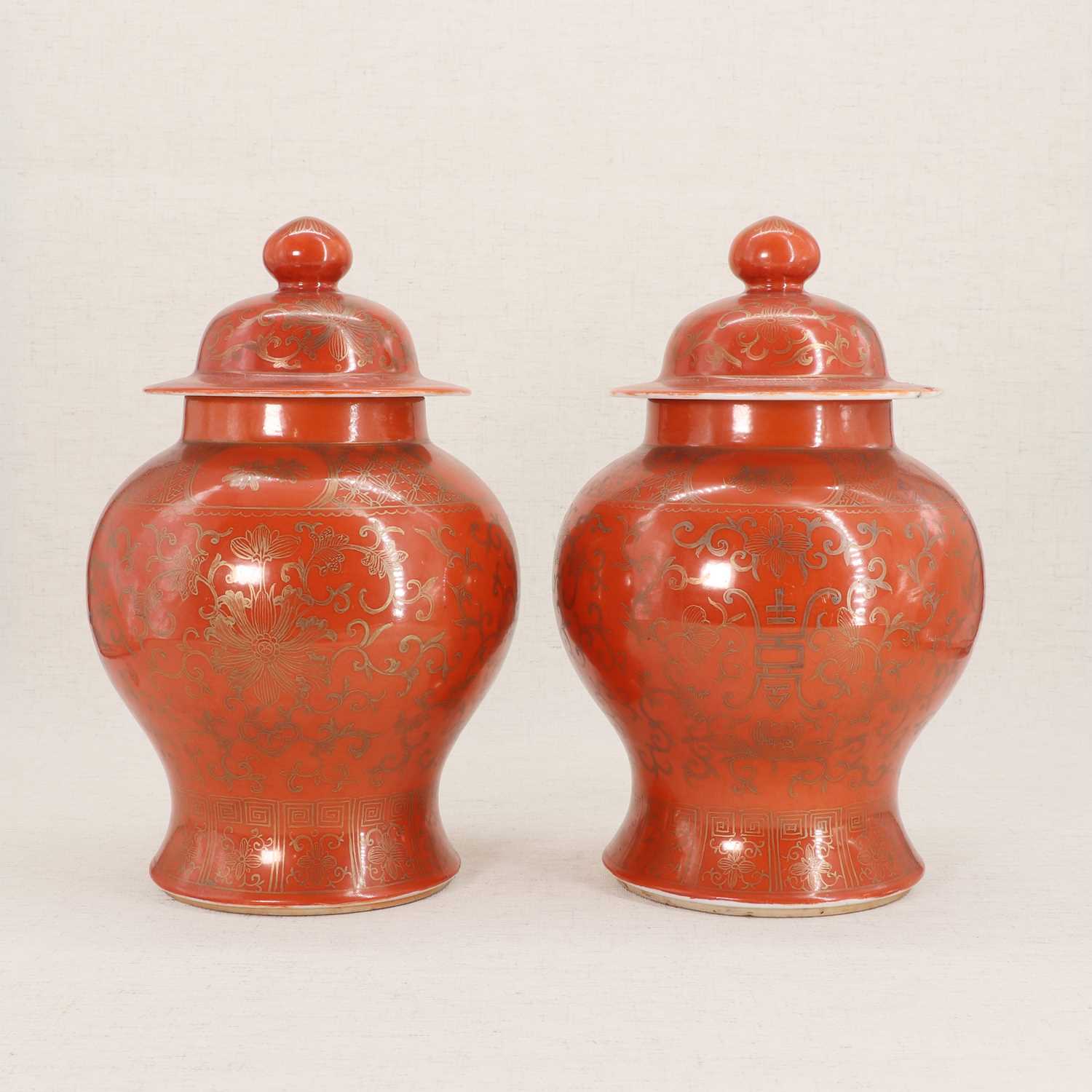 Lot 51 - A pair of Chinese coral-ground vases and covers