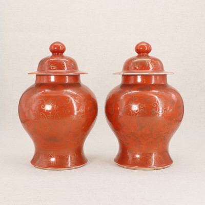 Lot 51 - A pair of Chinese coral-ground vases and covers