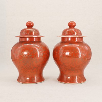 Lot 51 - A pair of Chinese coral-ground vases and covers