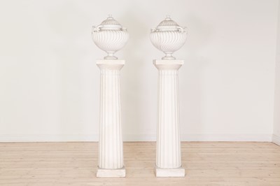 Lot 103 - A pair of plaster urns on pedestals
