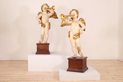 Lot 76 - A pair of painted and parcel-gilt wooden putti