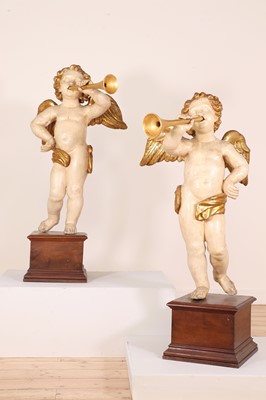 Lot 76 - A pair of painted and parcel-gilt wooden putti