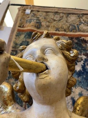 Lot 76 - A pair of painted and parcel-gilt wooden putti