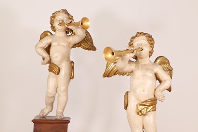 Lot 76 - A pair of painted and parcel-gilt wooden putti