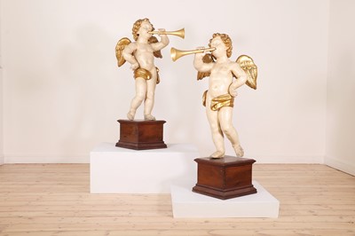 Lot 76 - A pair of painted and parcel-gilt wooden putti