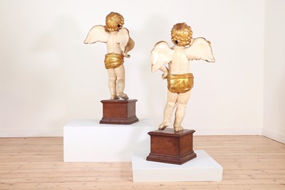 Lot 76 - A pair of painted and parcel-gilt wooden putti