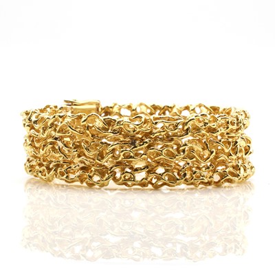 Lot 180 - An American molten effect gold three row bracelet, c.1970