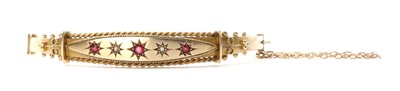 Lot 1038 - An Edwardian gold doublet and diamond set hollow oval bangle