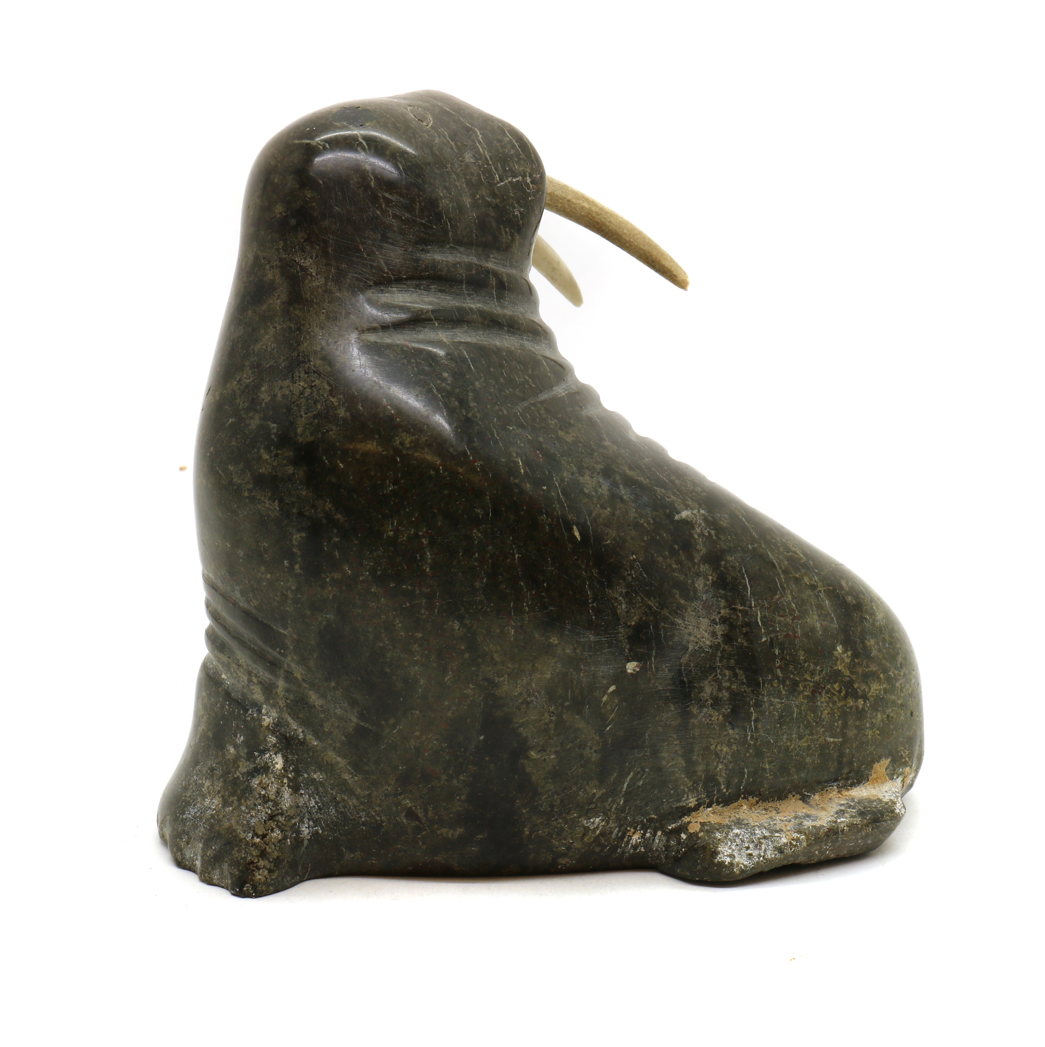 Lot 253 - An Inuit argillite carving,