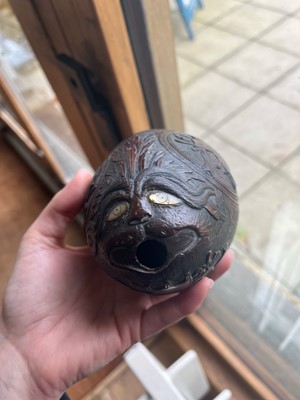 Lot 101 - A carved 'bugbear' coconut flask