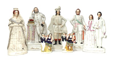 Lot 203 - A group of twenty Staffordshire porcelain figures