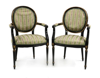 Lot 390 - A pair of ebonised and parcel gilt Louis XVI style fauteuils