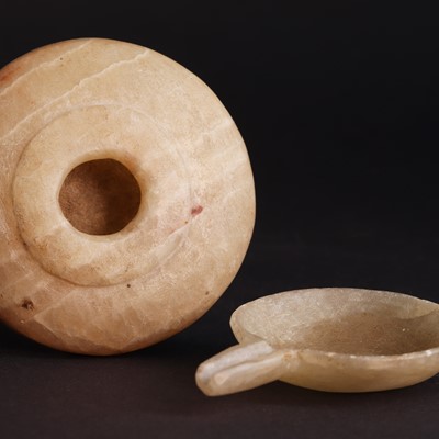 Lot 215 - An Ancient Egyptian alabaster cosmetic container