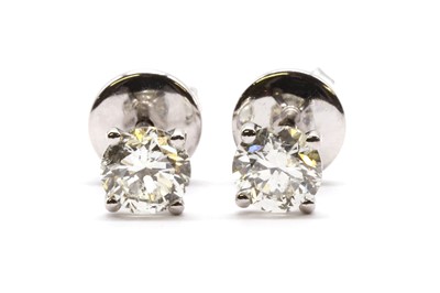 Lot 73 - A pair of 18ct white gold single stone diamond stud earrings