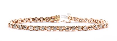 Lot 67 - A 9ct rose gold diamond line bracelet